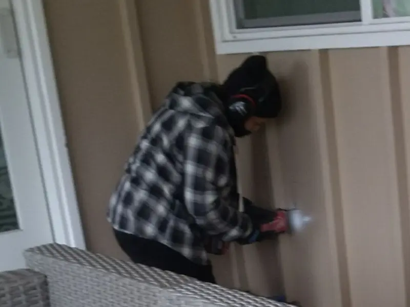 Professional electrician installing an exterior outlet in Gray