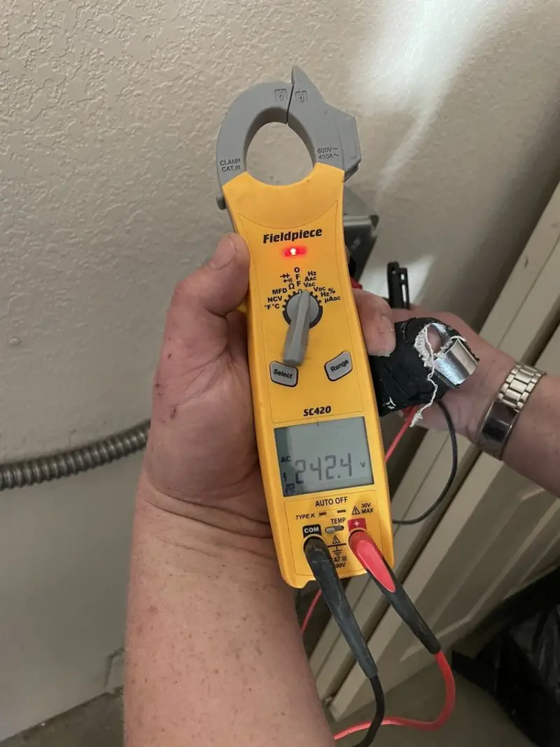 Voltage testing with clamp meter during Recessed Lighting Installation in Gray